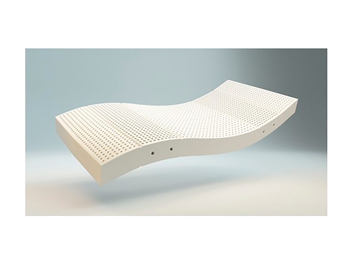 Gros plan sur le matelas Lagune en latex synthétique blanc, perforé pour une aération optimale, Confort ferme.